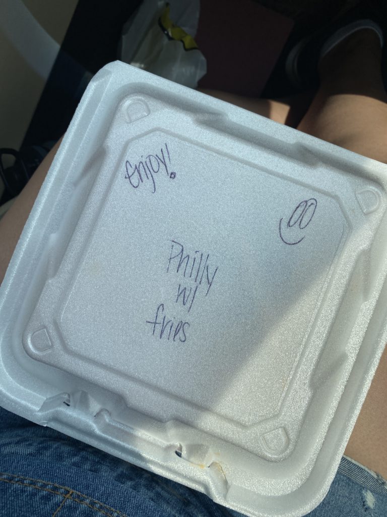 Takeout container of food with Philly cheesesteak and fries from Baba's grill in Newark, Ohio.