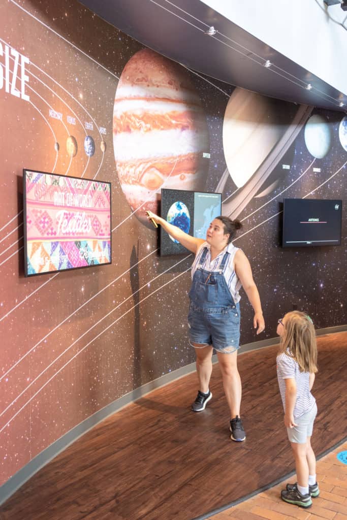 Family learning about planets at The Works kids museum in Newark, Ohio.