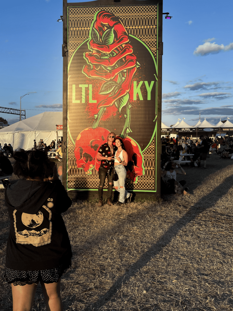 Guy and girl posing at Louder than Life Music Festival in Louisville, KY.